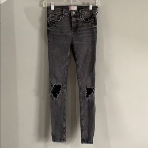 Mid rise faded black ripped jeans